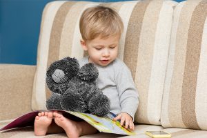 Boy Reading to Teddy Bear