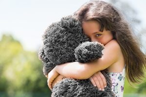 Girl Hugging teddy bear